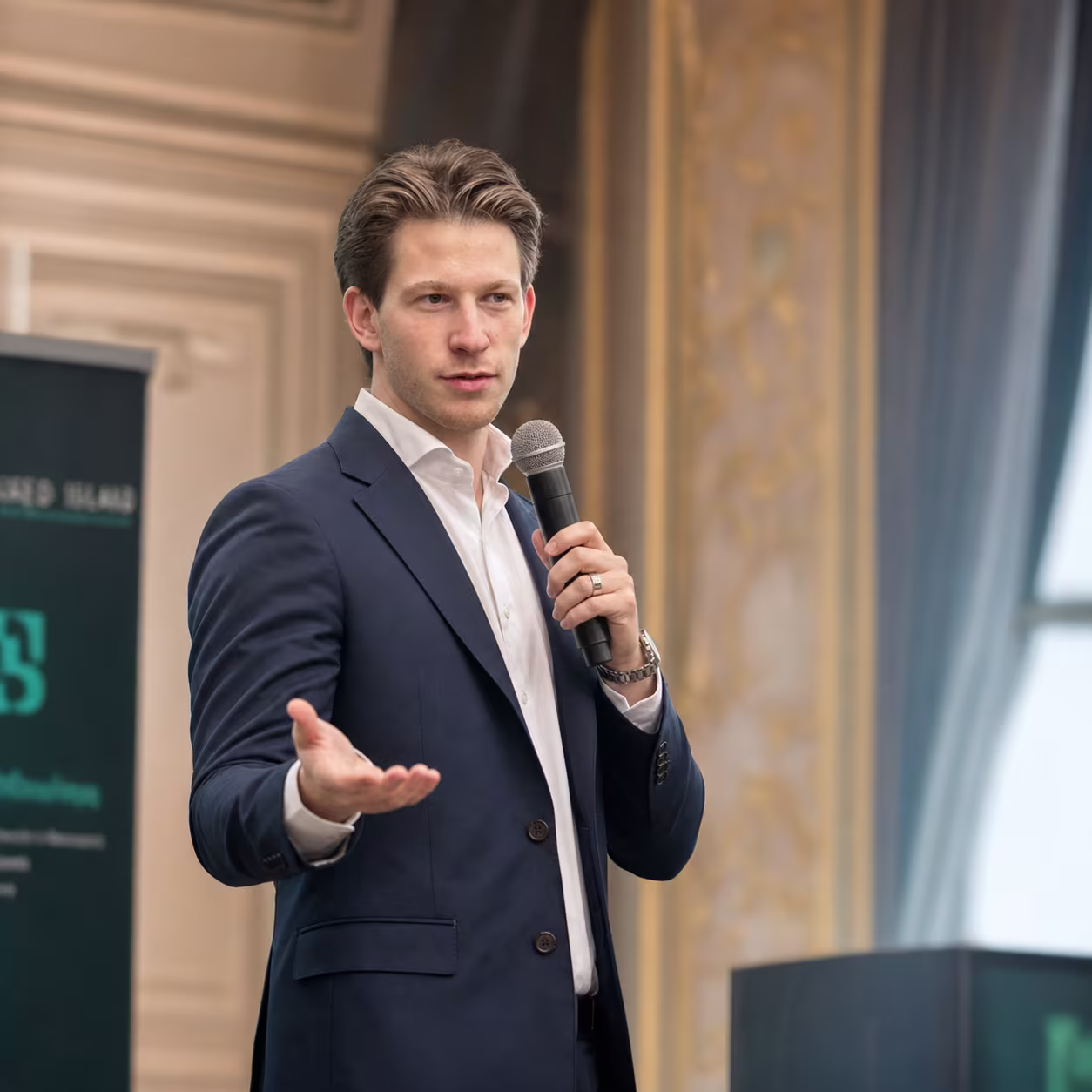 Dima, founder of Hired Island, speaking on stage